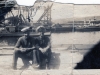 2-Sailors-Sitting-on-some-Docks